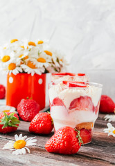 Strawberries with cream or tiramisu in small glasses 