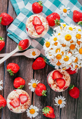 Strawberries with cream or tiramisu in small glasses 