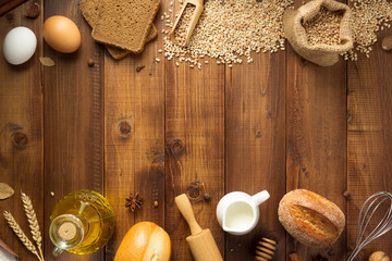 wheat grains and bakery ingredients on wood