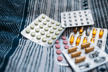 Assorted pharmaceutical medicine pills, tablets and capsules. Pills on lifestile background...