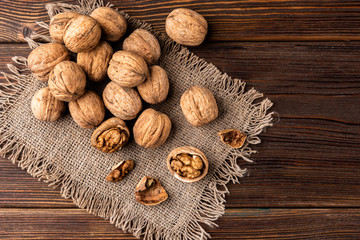 Walnut on dark wooden background.