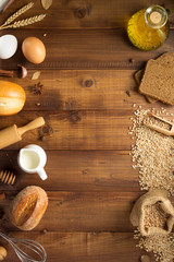 wheat grains and bakery ingredients on wood