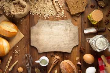 wheat grains and bakery ingredients on wood