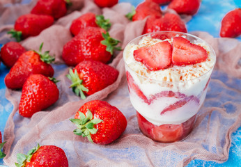 Strawberries with cream or tiramisu in small glasses 