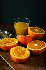 Oranges and squeezer on wooden table