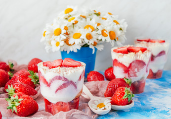 Strawberries with cream or tiramisu in small glasses 