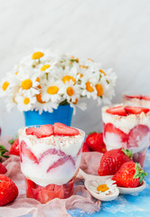 Strawberries with cream or tiramisu in small glasses 