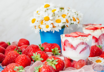 Strawberries with cream or tiramisu in small glasses 