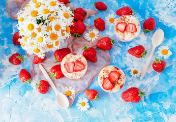 Strawberries with cream or tiramisu in small glasses 
