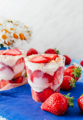 Strawberries with cream or tiramisu in small glasses 