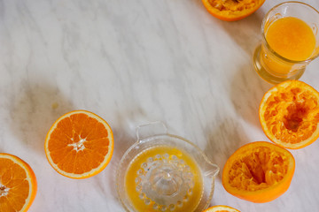 Oranges and squeezer on marble table