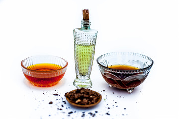 Close up of best home remedy or ayurvedic home remedy to increase hair growth naturally isolated i.e. Shikakai well mixed with honey olive oil and water on white surface with all the ingredients,