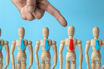 Staff recruitment. Choosing a leader for a business team. The employer giver points his finger at the worker in the red tie