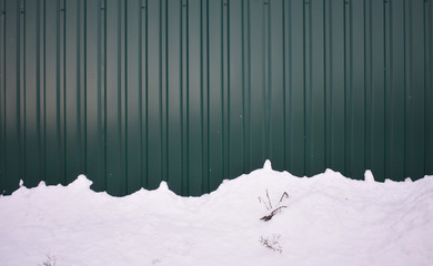 Snow near the fence.