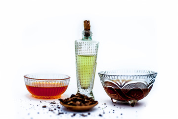 Close up of best home remedy or ayurvedic home remedy to increase hair growth naturally isolated i.e. Shikakai well mixed with honey olive oil and water on white surface with all the ingredients,