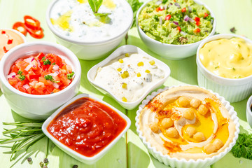 Selection of sauces in white bowls on white bowls, top view