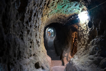 underground ancient stone tunnel with lights