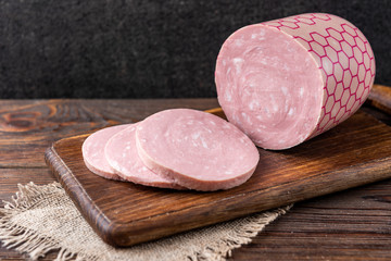 Boiled sausage on wooden background. 
