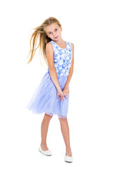 Little girl in a dress developing in the wind.