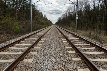 Fototapeta na wymiar Double railway tracks perspective as a convergent pattern.