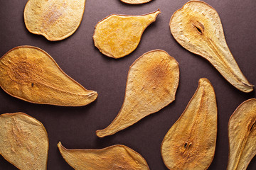 Slides thinly sliced pears drying in the sun, background. Dried pears
