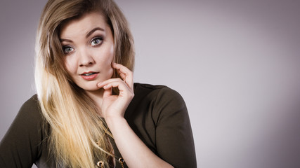 Attractive blonde woman wearing tight green khaki dress