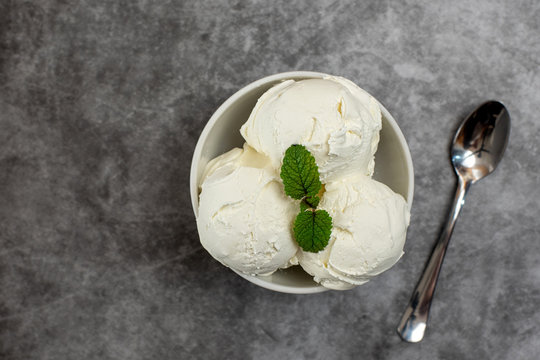 Bowl Of Vanilla Ice Cream On Grey Background. From Top View