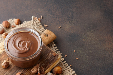 Chocolate spread with hazelnuts on brown countertop