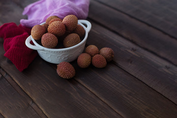 lychees litchi in a white plate on a wooden background