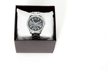 wrist watch with a black dial, in a black box, on a white background, is isolated