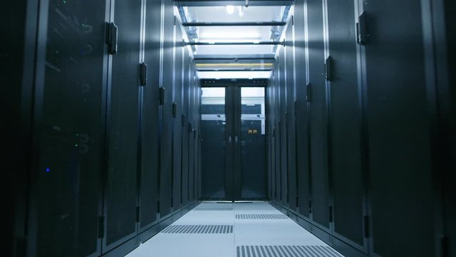 Data Center With Between Two Rows of Fully Operational Server Racks. Concept of Telecommunications, Cloud Computing, Artificial Intelligence, Database, Supercomputer Technology. Low Angle Backway Shot