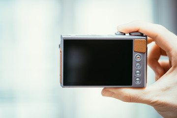Backside of a modern digital camera, black screen