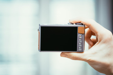 Backside of a modern digital camera, black screen
