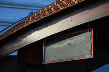 empty traditional store front vintage retro wood signboard with blank space wooden building background ready to put on names, signs, messages or logos. Advertising, Outdoor Media and Branding concept