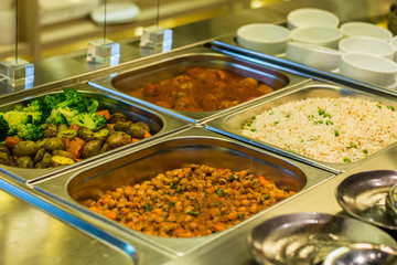 Salad bar with vegetables, chickpeas, rice, olives
