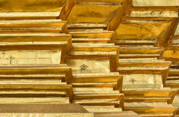 Lines and angles abstract of gilded metal sheet covering pagoda in traditional Thai Temple.