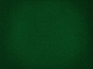 Texture of cardboard closeup, dark green abstract paper background.