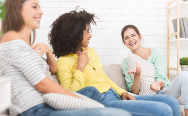 Happy friends chatting at home, having friendly talk