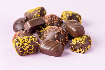 Different Type of Chocolate Candies on Pink Background Tasty Chocolate Candies Dessert Close Up Horizontal