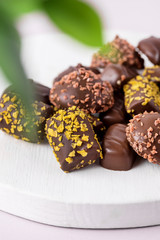 Different Type of Chocolate Candies on Pink Background Tasty Chocolate Candies Dessert Close Up Vertical