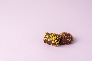 Two Tasty Chocolate Candies on Pink Background Horizontal Copy Space Beautiful Candies