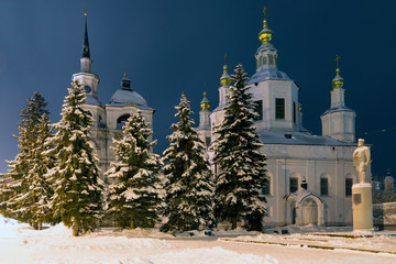 Cathedral of the Assumption (Uspensky Sobor) in the winter night, with snow covered spruces. Veliky Ustyug, Vologda Region, Russia.
