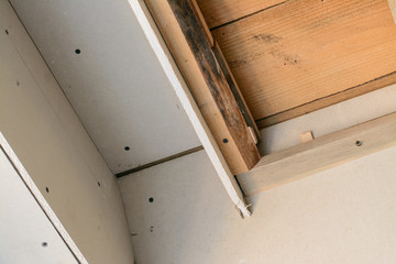 Construction room with drywall. Making suspended ceiling using wooden frame and drywall in a private house