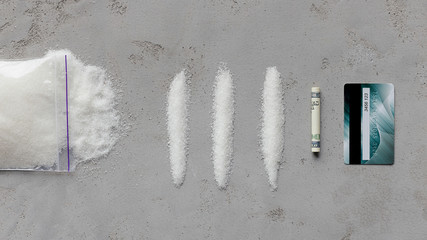 Dose of sugar like cocaine powder and dollar bill scroll