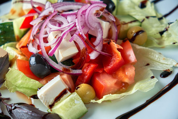 Greek salad with fresh vegetables, feta cheese and black olives