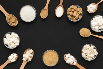 Various types of sugar on black background.
