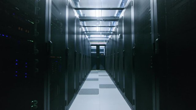 Data Center With Two Rows of Fully Operational Server Racks. Concept of Telecommunications, Cloud Computing, Artificial Intelligence, Database, Supercomputer Technology. Fast Retreating Backway Shot