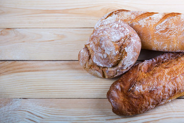 Fresh bread on rustic wooden table with copy space for your text