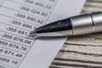 Close-Up of Business Document and Ballpoint Pen Lying on table