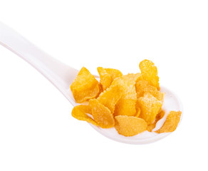 Corn flakes in spoon isolated on white background